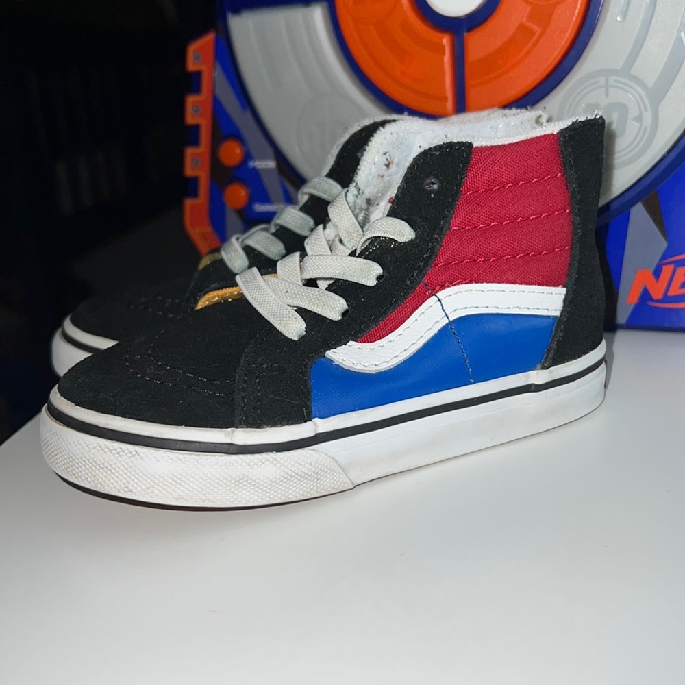 Black suede Vans with red blue and white
